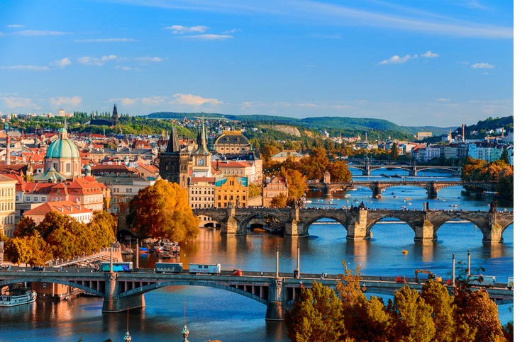 View of the Vltava River and Charle bridge with red foliage, Prague, Czech Republic